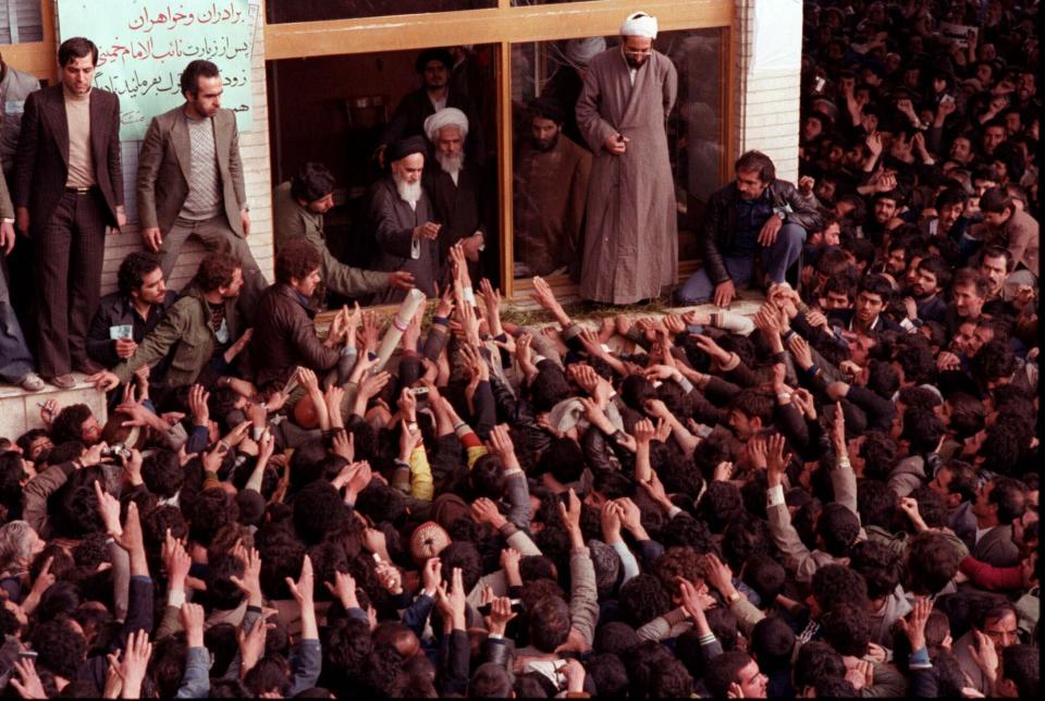 FILE - In this Feb. 2, 1979 file photo, Ayatollah Ruhollah Khomeini, center, is greeted by supporters in Tehran, Iran. Friday, Feb. 1, 2019 marks the 40th anniversary of Iran’s exiled Ayatollah Ruhollah Khomeini return to Tehran, a moment that changed the country’s history for decades to come. That revolution would spark the U.S. Embassy takeover and hostage crisis, stoking the animosity that exists between Tehran and Washington to this day. (AP Photo, File)