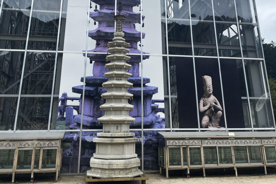 A pagoda replica sits in front of the octagonal, nine-story pagoda, which is under maintenance. On the right is an image of the stone Bodhisattva that was moved to Woljeongsa Museum. (Photo: Lim Yian Lu)