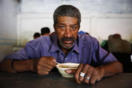 Felix Ramirez, 67, poses for a picture at the Mother Teresa of Calcutta eating center in Caracas April 8, 2014. REUTERS/Carlos Garcia Rawlins