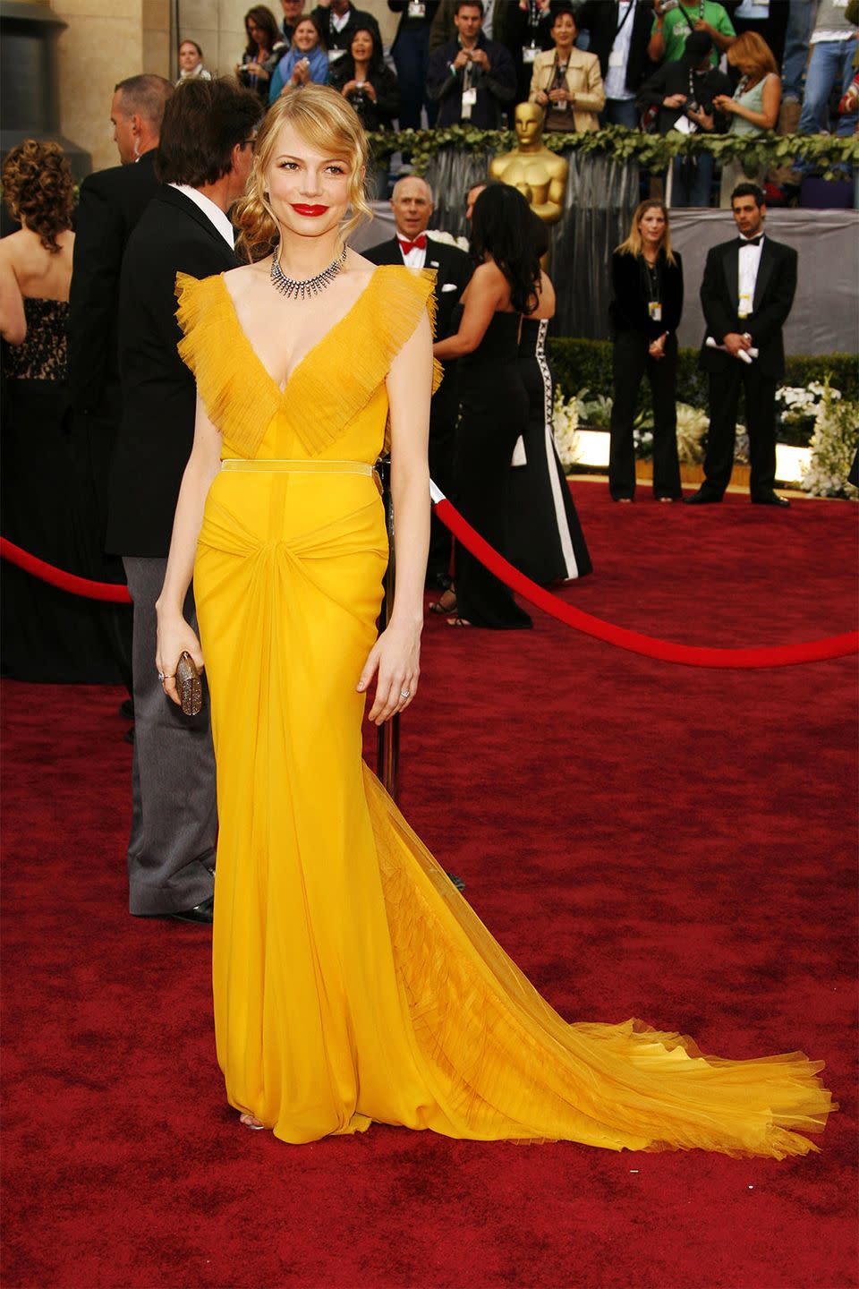 <p>Michelle Williams's saffron Vera Wang dress has become one of the most memorable fashion moments. The actress attended with her then-boyfriend, the late Heath Ledger, who was nominated for his role in <em>Brokeback Mountain, </em>where they both met. </p>