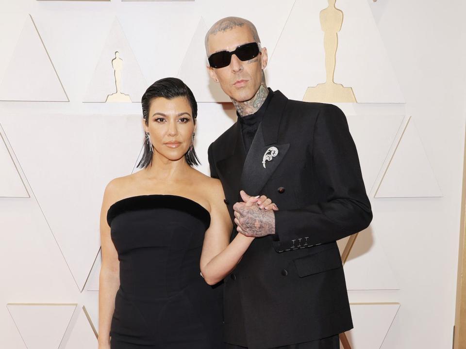 Kourtney Kardashian and Travis Barker at the 2022 Oscars.