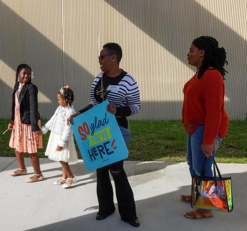 Greeter Carline Larson, center, welcomes worshipers to Sunday service on January 21, 2024, in Miami Gardens, Florida. The Assemblies of God church sold its eight-acre property to developers in 2022, and the church rebranded to Collab.Church the same year at operates temporarily inside the auditorium of the North Dade Middle School. Carl Juste/cjuste@miamiherald.com