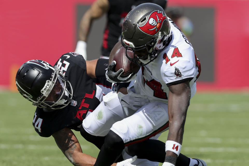 Tampa Bay Buccaneers wide receiver Chris Godwin (14) is hit by Atlanta Falcons cornerback A.J. Terrell (24) during the first half of an NFL football game, Sunday, Oct. 22, 2023, in Tampa, Fla. (AP Photo/Mark LoMoglio)