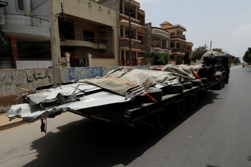 A truck loaded with the wreckage of the crashed Pakistan International Airlines' PK8303 plane, is pictured after it was retrieved from the roof of a house at the crash site, in Karachi,