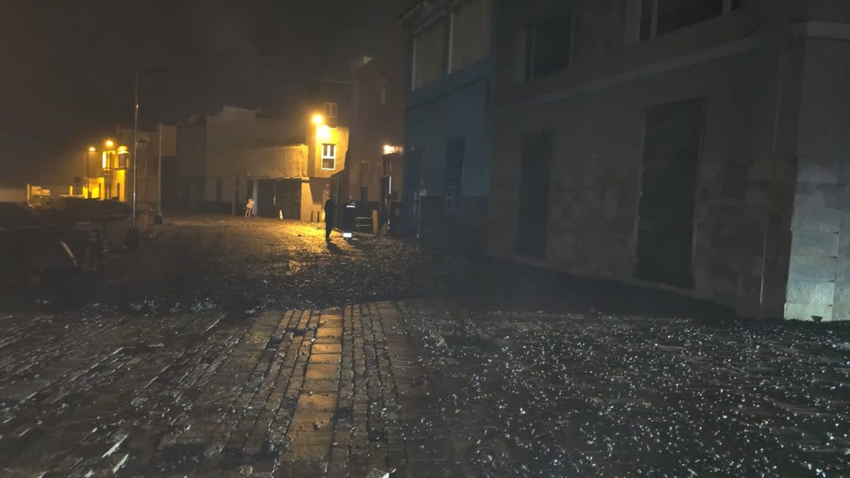 Debris could be seen strewn across the seafront with broken tiles caused by the deluge (Police handout)