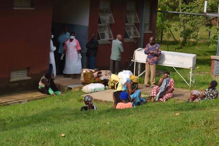 People are seen in the courtyard as Ugandan medical staff inspect the ebola preparedness facilities at the Bwera general hospital near the border with the Democratic Republic of Congo in Bwera