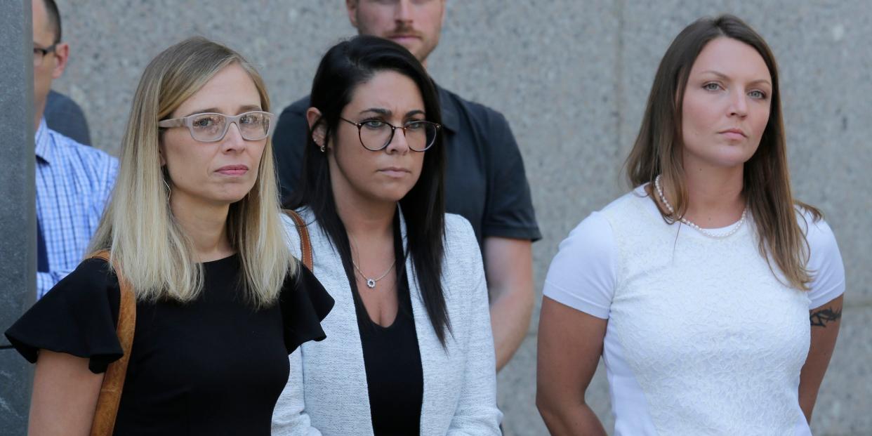 Annie Farmer, left, and Courtney Wild, right, accusers of Jeffery Epstein, stand outside the courthouse in New York, Monday, July 15, 2019. 