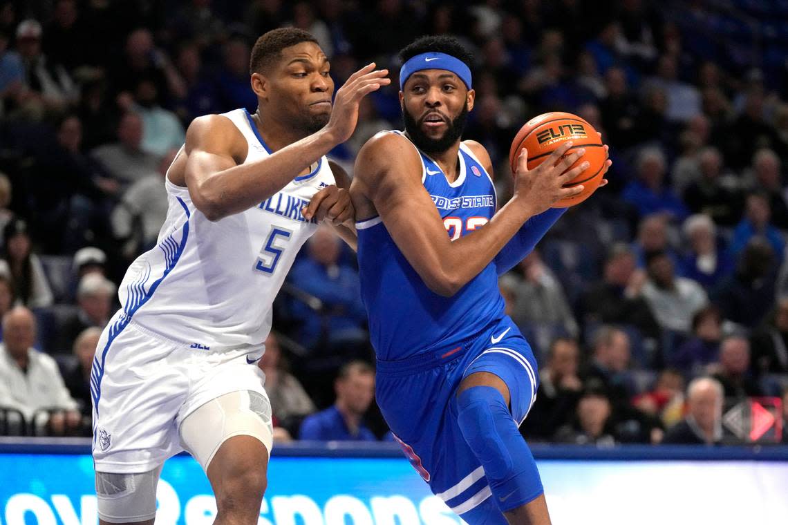 Boise State’s Naje Smith, right, drives to the basket past Saint Louis’ Francis Okoro (5) during the first half of an NCAA college basketball game Saturday, Dec. 10, 2022, in St. Louis. (AP Photo/Jeff Roberson)