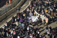 Hundreds of demonstrators march through Minneapolis following protests near the Hennepin County Government Center, Monday, March 8, 2021, in Minneapolis where the trial for former Minneapolis police officer Derek Chauvin began with jury selection. Chauvin is charged with murder in the death of George Floyd during an arrest last May in Minneapolis. (AP Photo/Jim Mone)