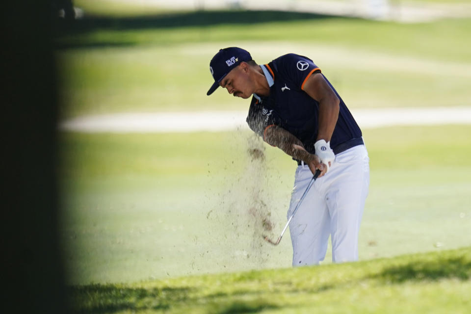 Rickie Fowler hits out of the sand on the seventh hole during the first round of the Charles Schwab Challenge golf tournament at the Colonial Country Club in Fort Worth, Texas, Thursday, June 11, 2020. (AP Photo/David J. Phillip)
