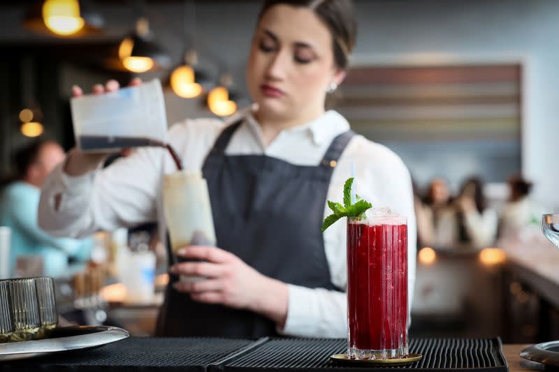 A bartender serves a cocktail based on the Chinese spirit Baijiu, in New York