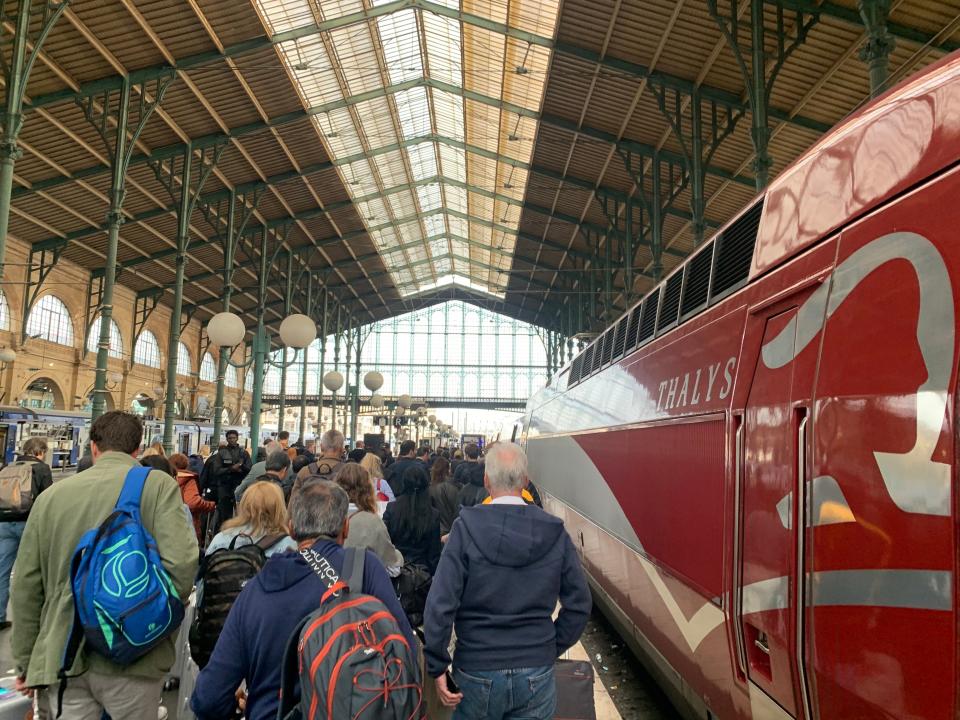 people lining up to get on a train at gare du nord station in paris