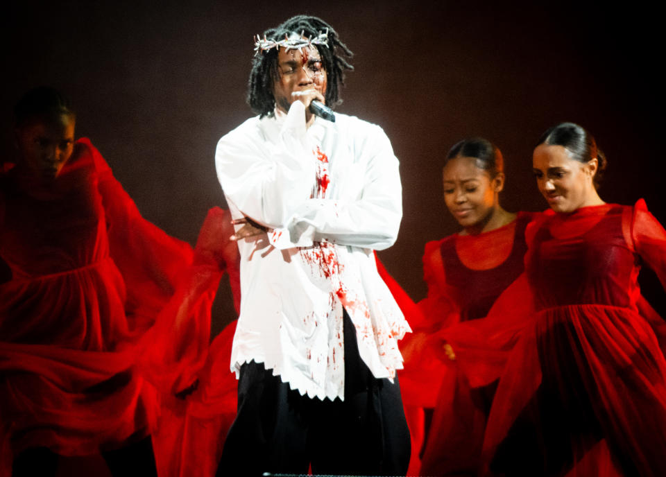 <p>Kendrick Lamar performs with a Tiffany & Co. crown of thorns on June 26 while at the Glastonbury Festival in Somerset, England. </p>