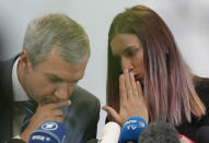 Belarusian dissident in Poland, Pavel Latushka, left, and Belarusian Olympic sprinter Krystsina Tsimanouskaya, right, who came to Poland fearing reprisals at home after criticizing her coaches at the Tokyo Games, talk to journalists in Warsaw, Poland, Thursday, Aug. 5, 2021. (AP Photo/Czarek Sokolowski)