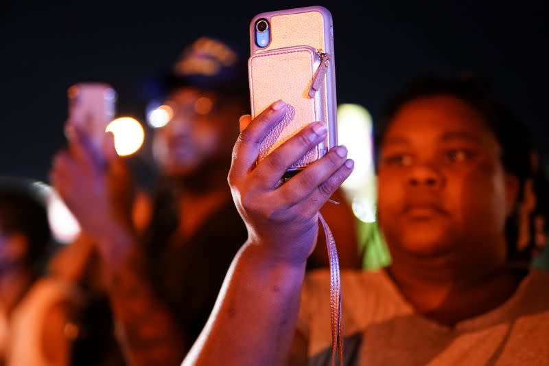 Protesters film the police during a rally against racial inequality and the police shooting death of Rayshard Brooks, in Atlanta