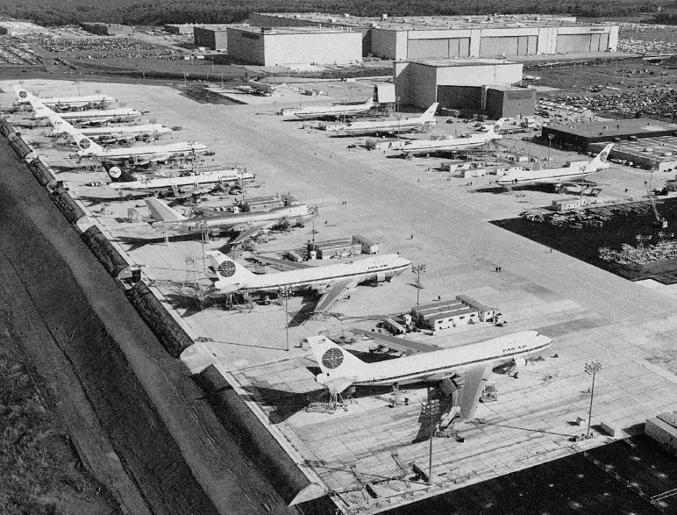 FILE - In this undated file photo, workers are dwarfed by the immensity of Boeing 747 jumbo jet nearing completion at the company's plant at Everett, Wash. For decades, the Boeing’s 747 was the Queen of the Skies. But the glamorous double-decker jumbo jet that revolutionized air travel and shrunk the globe could be nearing the end of the line. (AP Photo, File)