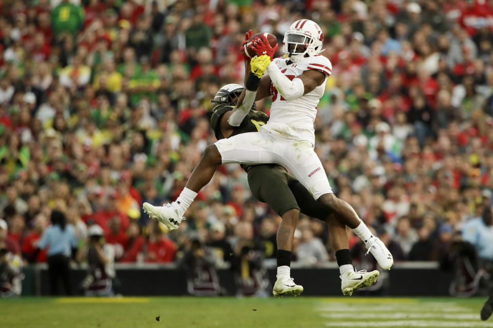 Wisconsin wide receiver Quintez Cephus catches a pass over Oregon safety Jevon Holland during second half of the Rose Bowl NCAA college football game Wednesday, Jan. 1, 2020, in Pasadena, Calif. (AP Photo/Marcio Jose Sanchez)