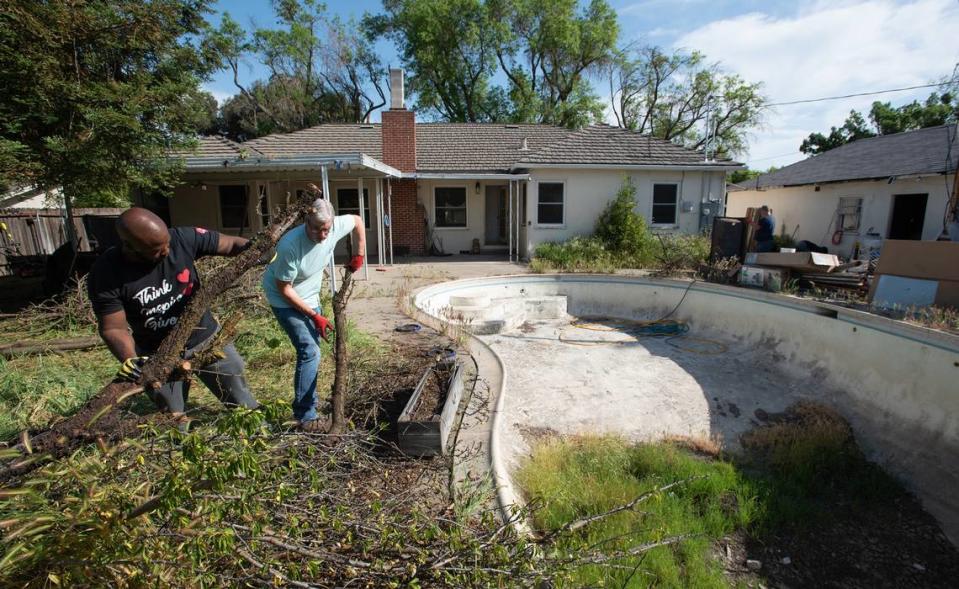 Volunteers Shedrick Bryant, left, and Ken Badovinac work on a home renovation project during Love Modesto community service day in Modesto, Calif., Saturday, April 29, 2023. This is the 15th year for the city-wide volunteer day.