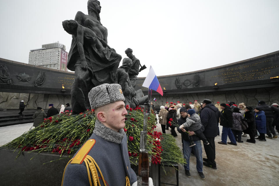 People place flowers during a commemoration ceremony at the monument of the Heroic Defenders of Leningrad, in St. Petersburg, Russia, Saturday, Jan. 27, 2024. The ceremony marked the 80th anniversary of the battle that lifted the Siege of Leningrad. The Nazi siege of Leningrad, now named St. Petersburg, was fully lifted by the Red Army on Jan. 27, 1944. More than 1 million people died mainly from starvation during the nearly900-day siege. (AP Photo/Dmitri Lovetsky)