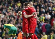 Liverpool captain Steven Gerrard (L) hugs teammate Martin Skrtel after winning their English Premier League soccer match against Norwich City at Carrow Road in Norwich April 20, 2014. REUTERS/Stefan Wermuth