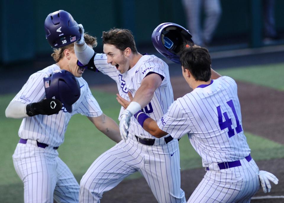 ACU's Bryson Hill celebrates with Miller Ladusau (left) and Tanner Tweedt (right) after hitting a home run on Tuesday.