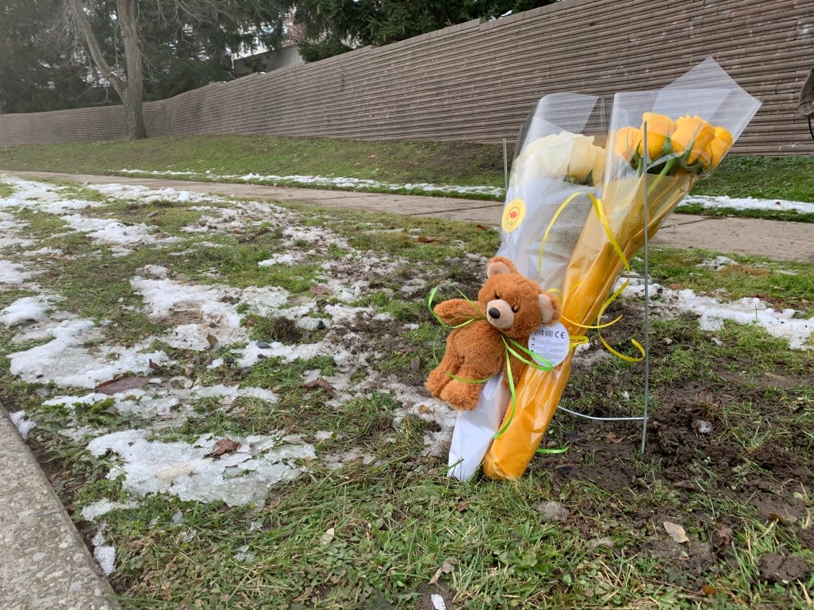 A makeshift memorial is beginning to form on Wednesday, Dec. 1, 2021, for an eight-year-old girl killed after a car jumped a curb and drove into a group of pedestrians, killing her and injuring 10 others Tuesday night in London, Ont. (Ellen Mauro/CBC - image credit)