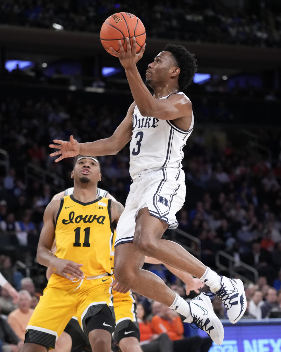 Duke's Jeremy Roach (3) shoots against Iowa's Tony Perkins (11) during the first half of the team's NCAA college basketball game in the Jimmy V Classic, Tuesday, Dec. 6, 2022, in New York. (AP Photo/John Minchillo)