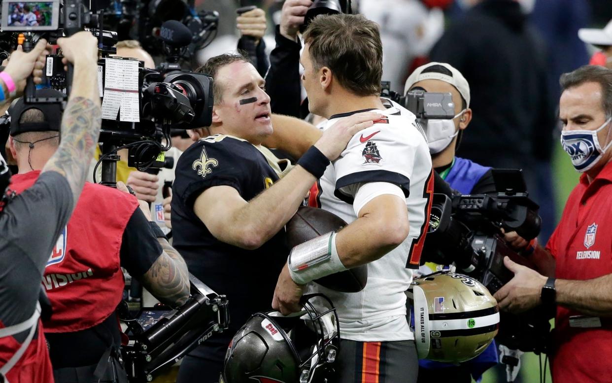 New Orleans Saints quarterback Drew Brees, center left, speaks with Tampa Bay Buccaneers quarterback Tom Brady after an NFL divisional round playoff football game, Sunday, Jan. 17, 2021, in New Orleans. - AP