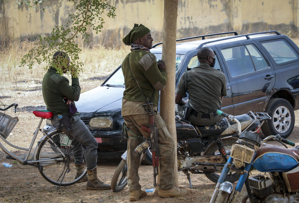 Security forces guard the Government Girls Junior Secondary School where more than 300 girls were abducted by gunmen on Friday, in Jangebe town, Zamfara state, northern Nigeria Sunday, Feb. 28, 2021. Families in Nigeria waited anxiously on Sunday for news of their abducted daughters, the latest in a series of mass kidnappings of school students in the West African nation. (AP Photo/Ibrahim Mansur)