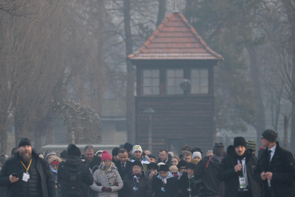 President Duda (centre left) is surrounded by Holocaust survivors and their families on his way to the Wall of Death.