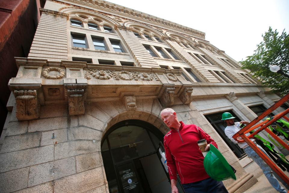 Denis Keohane, owner of Keohane Company, checks in on the former United Way Building on William Street in New Bedford which he is converting into twenty apartments.