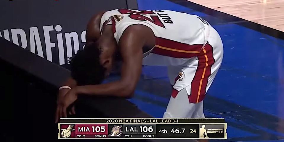 Screenshot shows Jimmy Butler doubled-over along the baseline during an NBA Finals game.