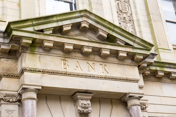 The front of a building with the words "Bank" written on it.