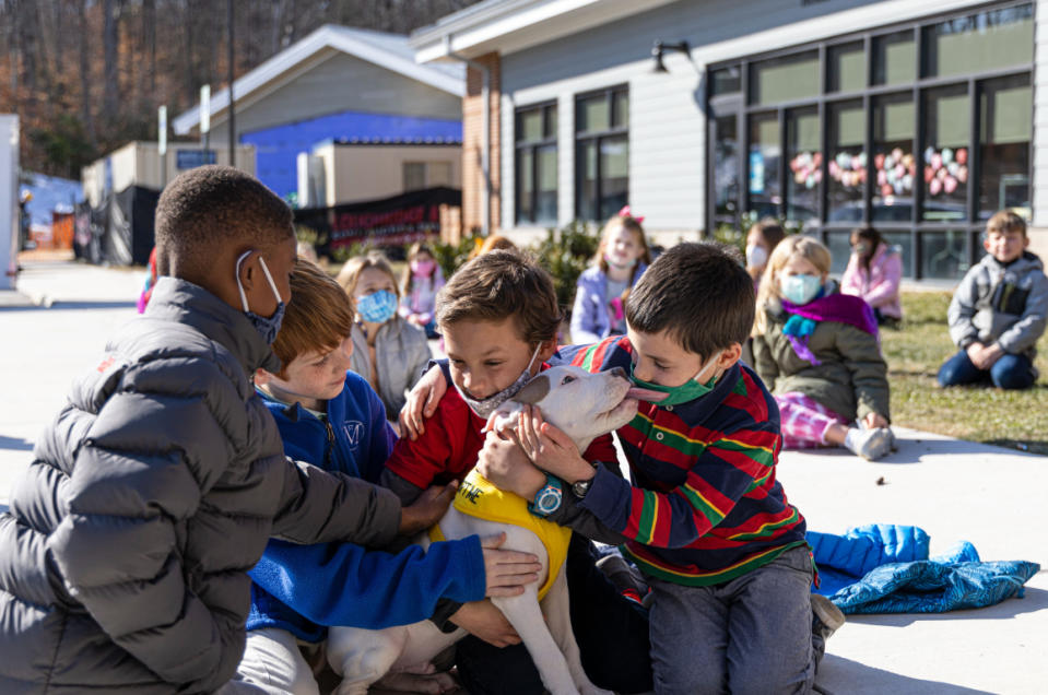 Getting to spend time with Snow, a puppy from Richmond Animal Care and Control shelter, helped the second graders really embrace their persuasive writing essays from the animals' point of view. (Courtesy St. Michael's Episcopal School)