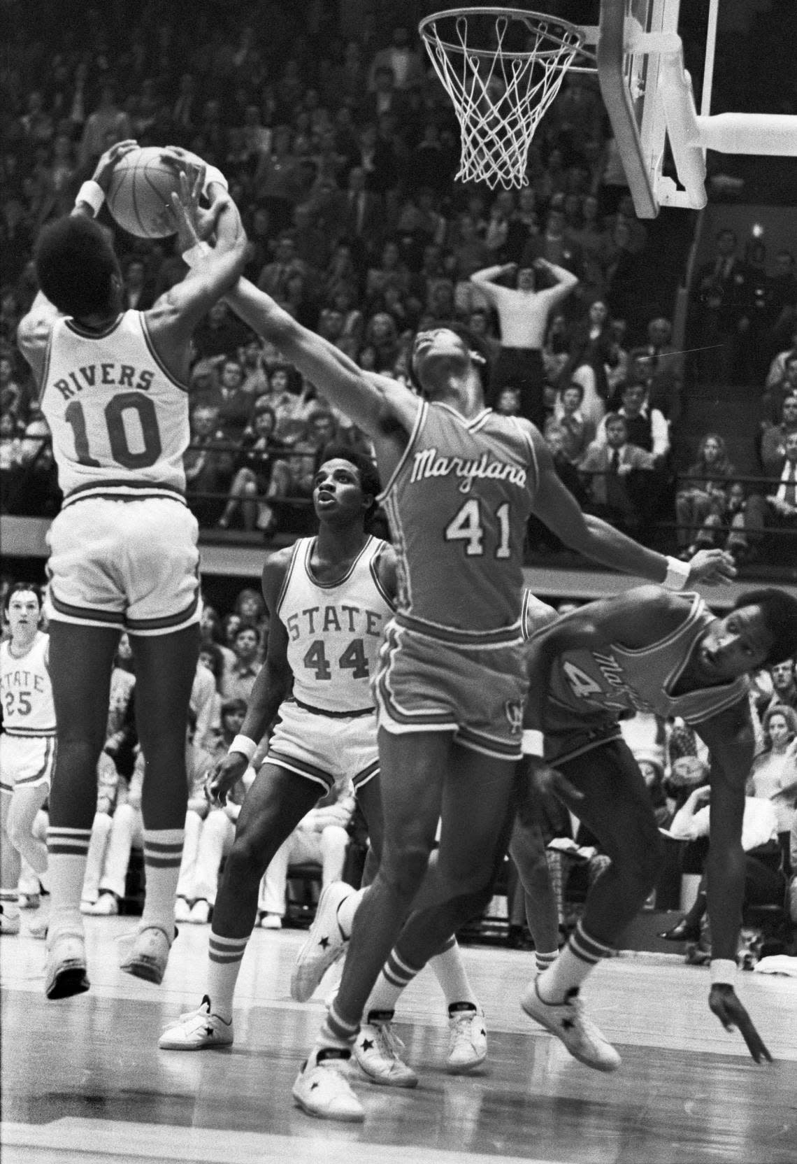 NC State’s Moe Rivers (10) battles for the ball with Maryland’s Len Elmore (41) during the Wolfpack’s win over Maryland in 1974 in Reynolds Coliseum.