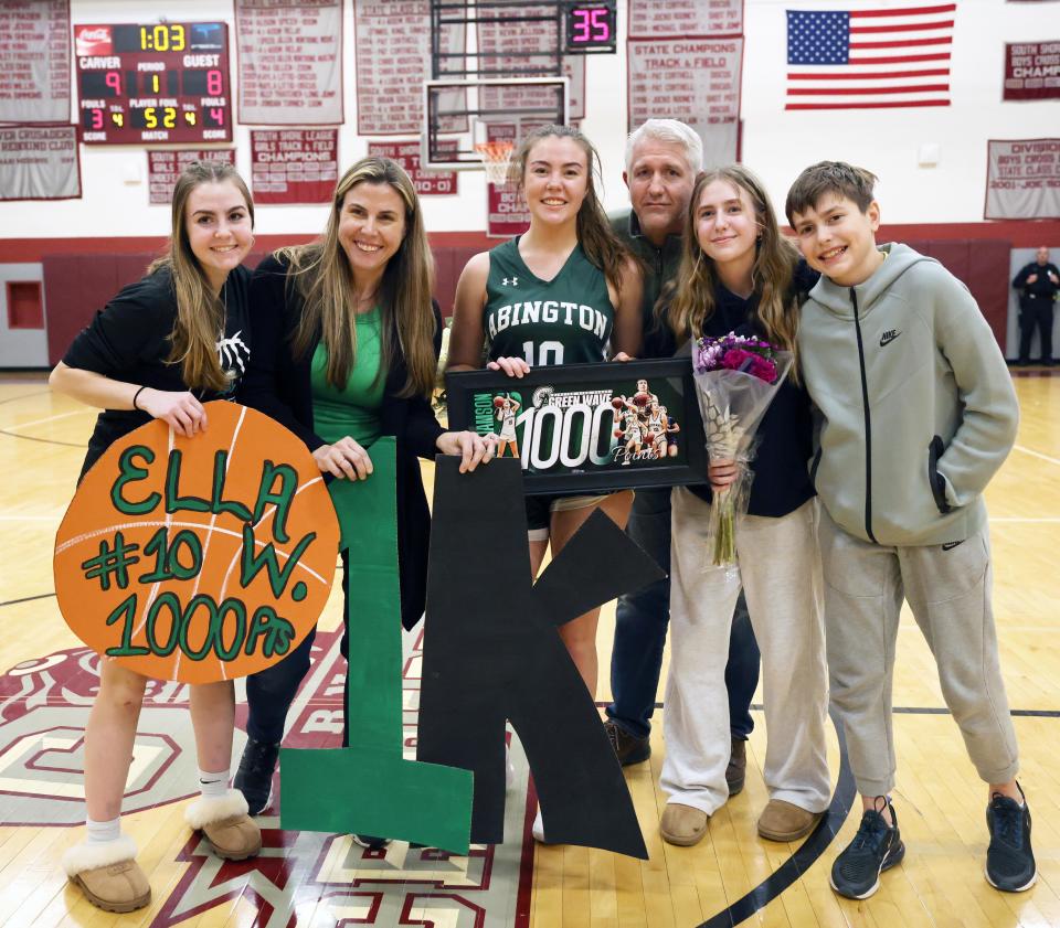 Abington High School co-captain Ella Williamson, 18, center, made a three-point basket to hit 1000-point mark and is congratulated by her parents Scott, and Katie with siblings Ava, 16, Lily, 13, and Charlie, 12, during a game versus Carver High School on Friday, Feb. 2, 2024.