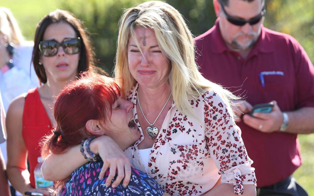 Parents wait for news after a reports of a shooting at Marjory Stoneman Douglas High School in Parkland, Florida - FR170673 AP