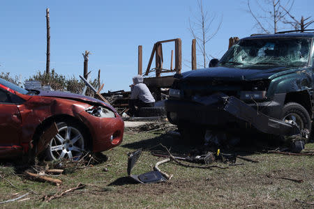 A woman sits outside a destroyed home after two deadly back-to-back tornadoes, in Beauregard, Alabama, U.S., March 5, 2019. REUTERS/Shannon Stapleton