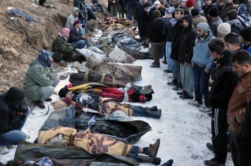 Locals gather in front of the bodies of people who were killed in a warplane attack on Ortasu village near Uludere, near the Iraq border in the southeastern Turkish province of Sirnak. Turkish warplanes killed 35 people on the Iraq border, officials said Thursday, in an attack Turkey's ruling party admitted could have mistakenly hit civilians instead of Kurdish separatists