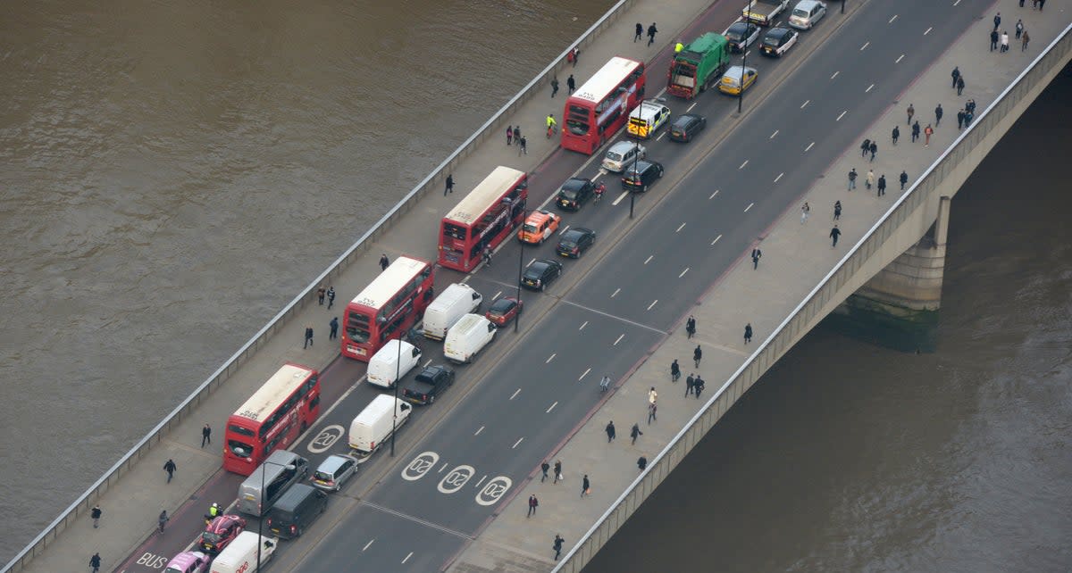 Buses and commuters drive along London Bridge (Anthony Devlin/PA) (PA Archive)