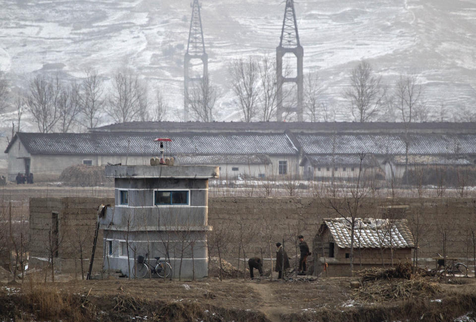 FILE - North Korean soldiers chat outside their post near the North Korean town of Sinuiju, opposite side to the Chinese border city of Dandong, on Dec. 21, 2011. North Korea is putting surveillance cameras in schools and workplaces, and collecting fingerprints, photographs and other biometric information from its citizens in a technology-driven push to monitor its population even more closely, a report said Tuesday, April 16, 2024. (AP Photo/Andy Wong, File)