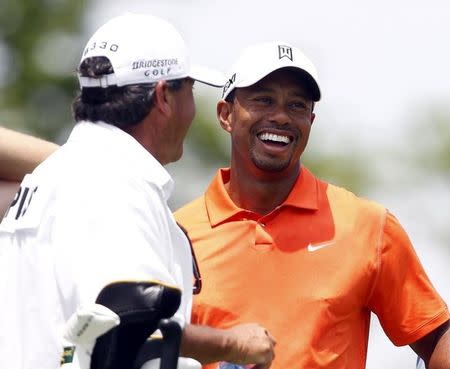 Tiger Woods of the U.S. with Fred Couple's caddie, Cayce Kerr (L), on the tee of the third hole during the first round of the Memorial Tournament at Muirfield Village Golf Club in Dublin, Ohio May 30, 2013. REUTERS/Matt Sullivan