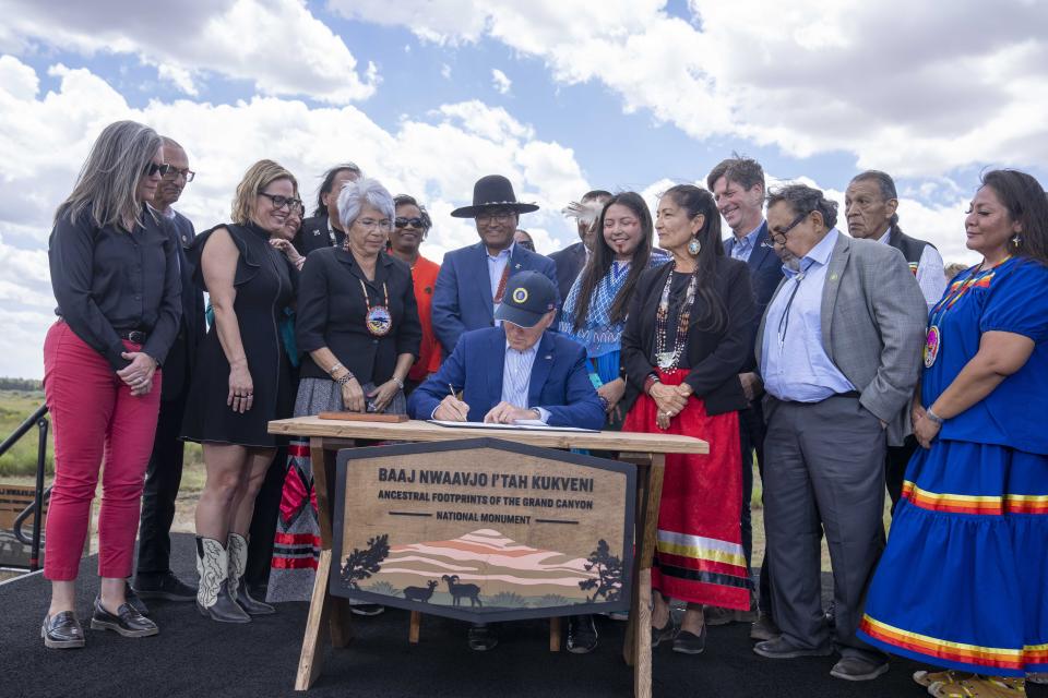 President Joe Biden signs a proclamation designating the Baaj Nwaavjo I'Tah Kukveni National Monument at the Red Butte Airfield Tuesday, Aug. 8, 2023, in Tusayan, Ariz. (AP Photo/Alex Brandon)