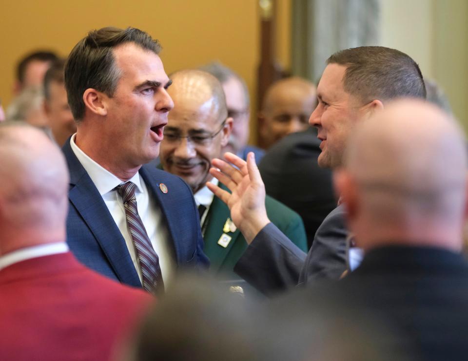 Rep. Anthony Moore, R-Clinton, right, greets Gov. Kevin Stitt as he arrives to give his State of the State address to the joint session on the first day of the Oklahoma Legislature on Monday.