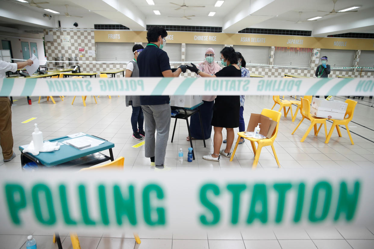 Personnel prepare ballot boxes at a polling station during Singapore's general election in Singapore July 10, 2020.  REUTERS/Edgar Su