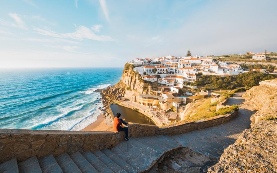 Picturesque Azenhas do Mar clings to the cliffs above the Atlantic Ocean, with natural rock pools beneath it that fill up at high tide - 2015 (2015 (Photographer) - [None]