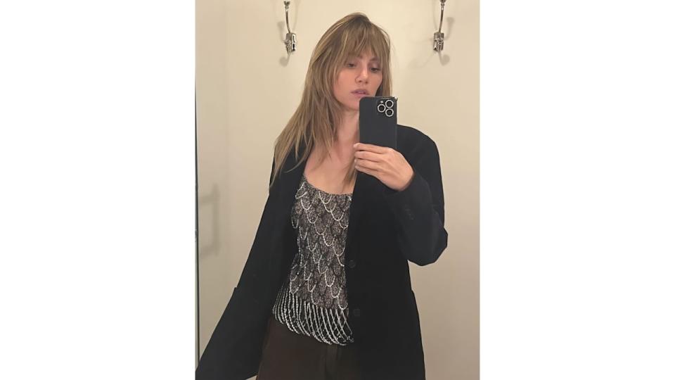 Suki Waterhouse poses in a blazer and sparkly tank top