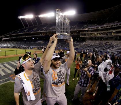 Madison Bumgarner holds up the Commissioner's Trophy after the Giants won the World Series. (AP)