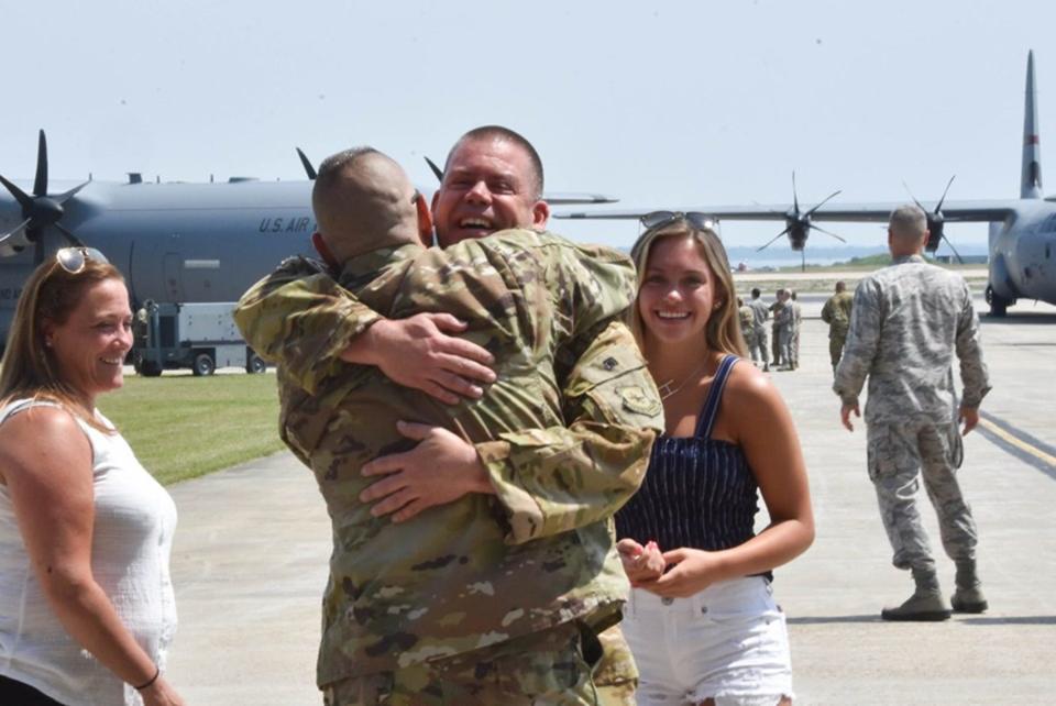 A Rhode Island National Guardsman is greeted by family after returning from an overseas deployment in 2019.