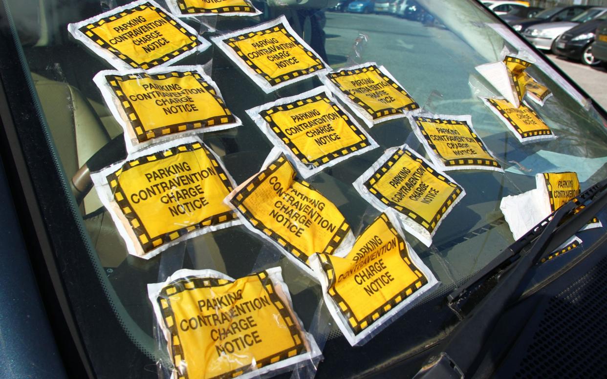 A car with multiple parking tickets  - www.Alamy.com